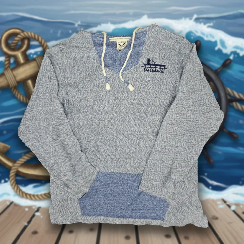 A heather blue pullover hoodie with a blue inner collar, cream drawstrings, and a blue kangaroo pocket, displayed against a nautical background with a ship's wheel, anchor, and wooden deck. The left chest area has a printed Docktails logo.