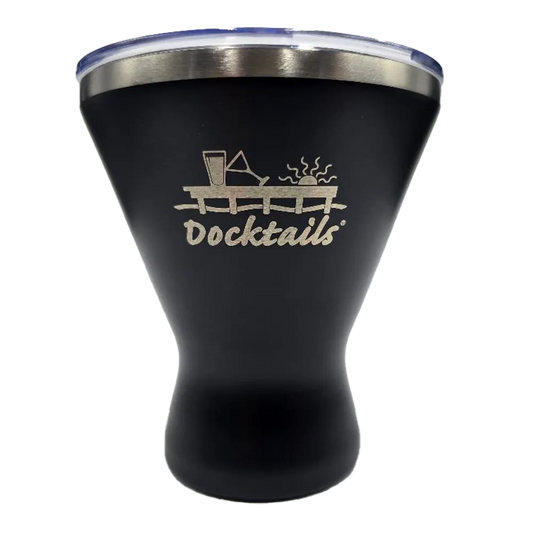 A black insulated tumbler with a clear lid and a silver stainless steel rim, featuring a laser-engraved graphic of a dock with a drink and the word 'Docktails' on the front.