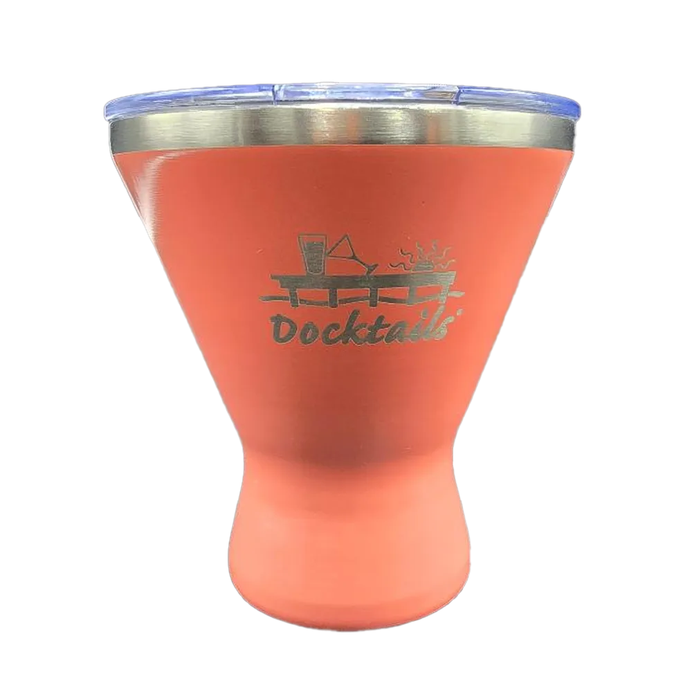 A coral insulated tumbler with a stainless steel rim and a clear lid, featuring a laser-engraved 'Docktails' logo with a cocktail glass and sun graphic on the front.