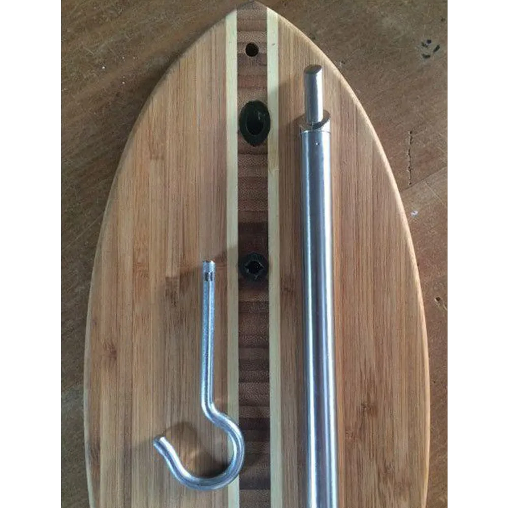 A wooden surfboard-style board with a metal mounting hook and a long silver pole attached, photographed from above on a wooden surface.