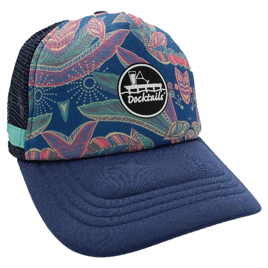 Navy blue trucker hat with floral main panel, navy mesh side panel with a turquoise fabric band, and a black Docktails logo patch on the crown.