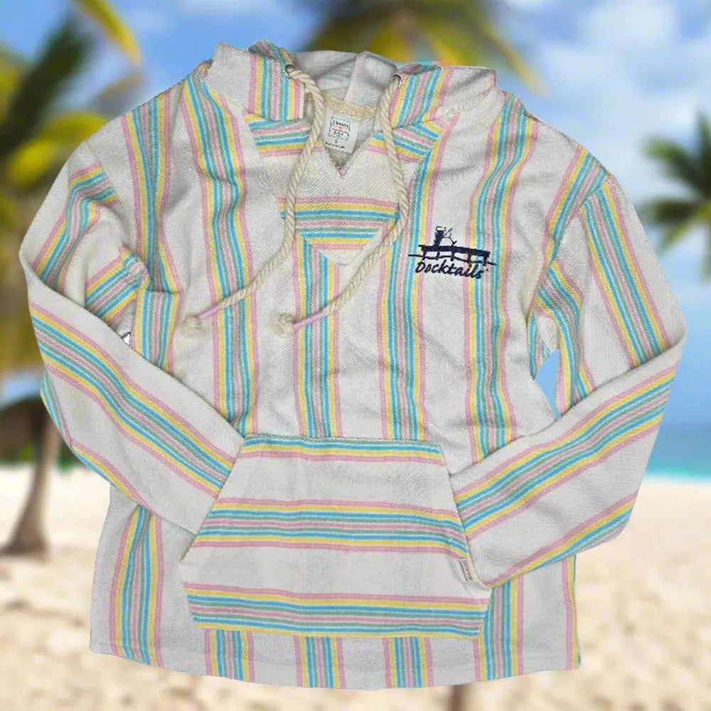 A long-sleeve hoodie with pastel stripes on an off-white base, featuring a drawstring hood and a chest graphic that reads 'Docktails'. The background is a blurred tropical beach scene with palm trees and sand.